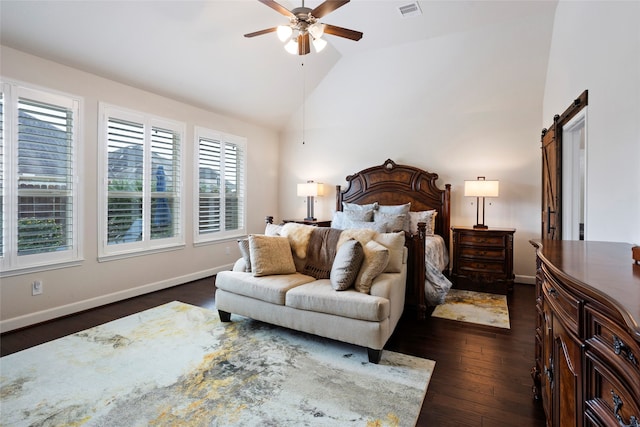 bedroom featuring ceiling fan, a barn door, dark hardwood / wood-style floors, and lofted ceiling