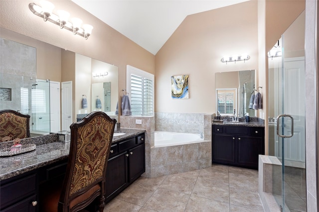 bathroom featuring plus walk in shower, vaulted ceiling, tile patterned floors, and vanity