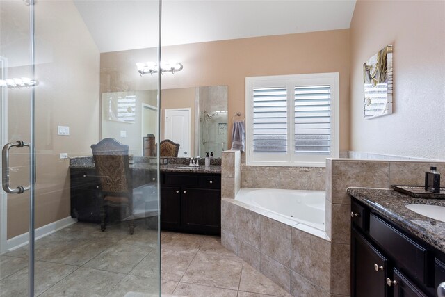 bathroom featuring independent shower and bath, tile patterned flooring, and vanity