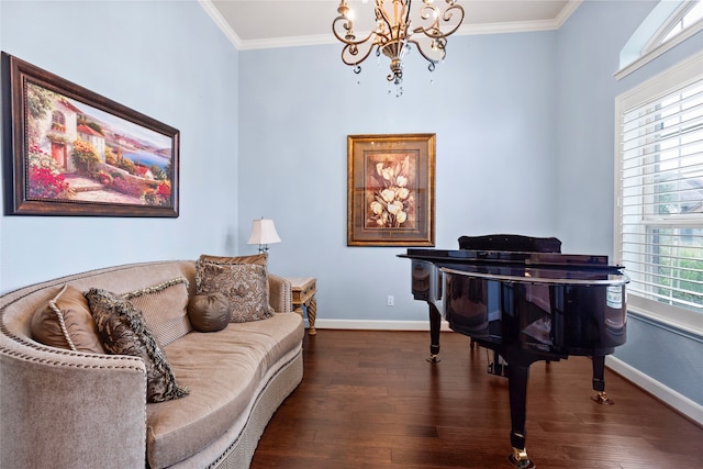 sitting room with dark wood-type flooring, a chandelier, and ornamental molding