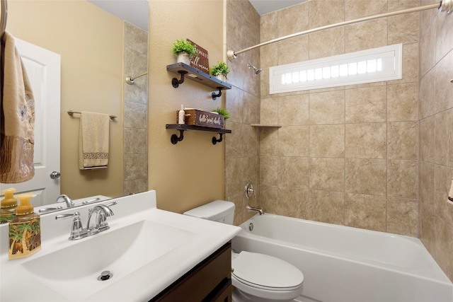 full bathroom with vanity, toilet, and tiled shower / bath combo