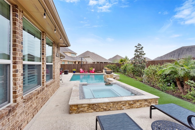 view of pool with an in ground hot tub and a patio area