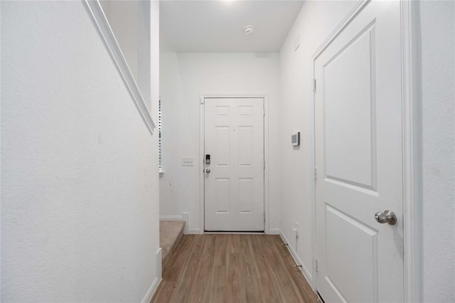 corridor with light hardwood / wood-style floors