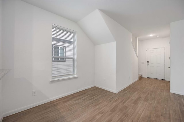 bonus room with hardwood / wood-style floors and lofted ceiling