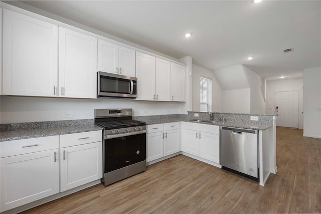 kitchen featuring light hardwood / wood-style flooring, sink, white cabinetry, light stone counters, and stainless steel appliances