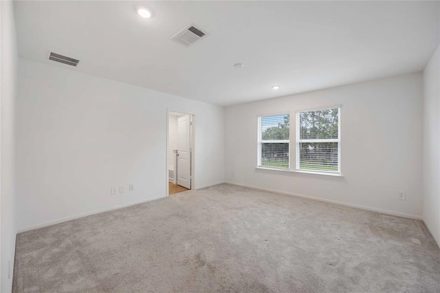 unfurnished room with light carpet