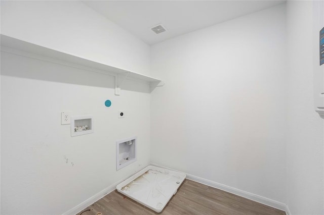 laundry area with washer hookup, electric dryer hookup, and wood-type flooring