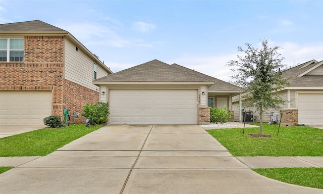 view of front of home featuring a garage, central air condition unit, and a front yard