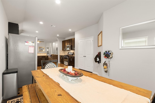 dining space featuring light hardwood / wood-style floors and ceiling fan