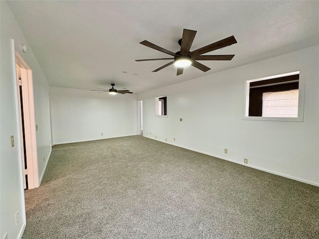 spare room featuring a wealth of natural light, ceiling fan, and carpet flooring