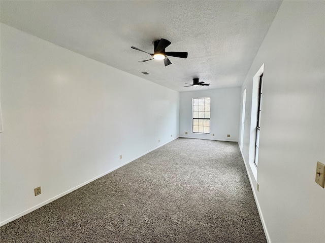 carpeted empty room with a textured ceiling and ceiling fan