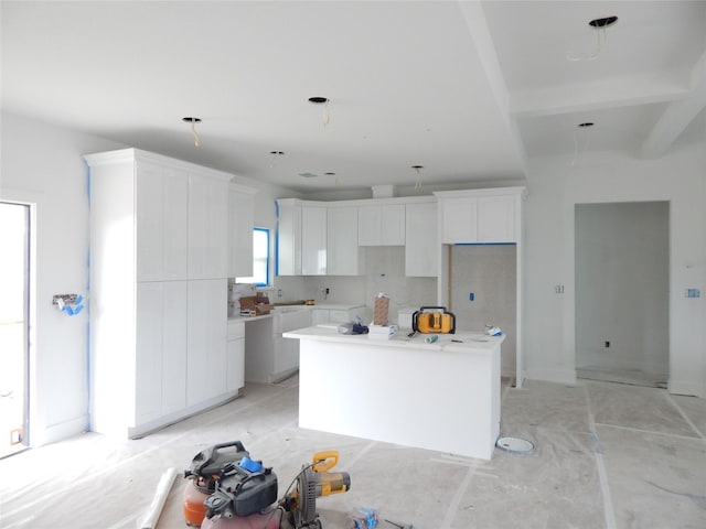 kitchen with a kitchen island and white cabinets