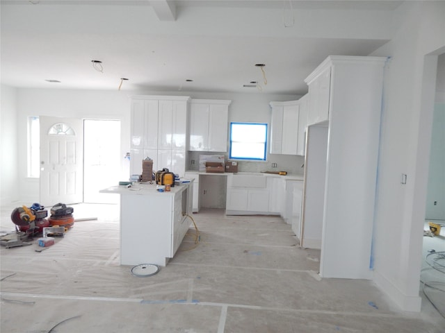 kitchen featuring white refrigerator, white cabinets, and a center island