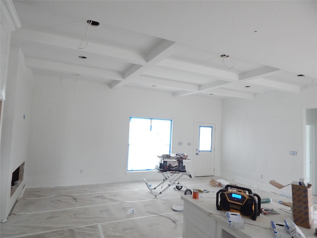 interior space featuring coffered ceiling and beam ceiling