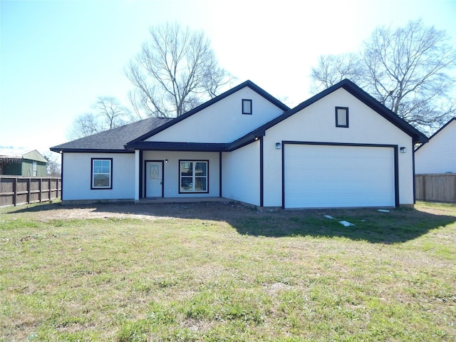 view of front facade with a garage, fence, driveway, and a front lawn