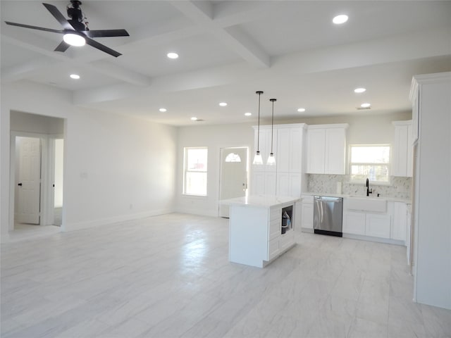 kitchen featuring a kitchen island, open floor plan, light countertops, dishwasher, and decorative light fixtures