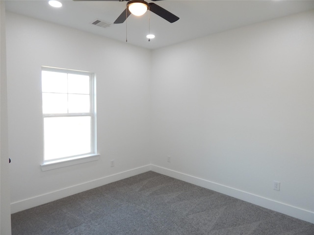 spare room with baseboards, visible vents, ceiling fan, dark colored carpet, and recessed lighting