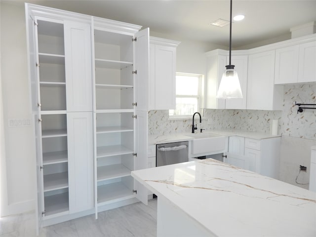 kitchen featuring white cabinetry, hanging light fixtures, stainless steel dishwasher, and open shelves