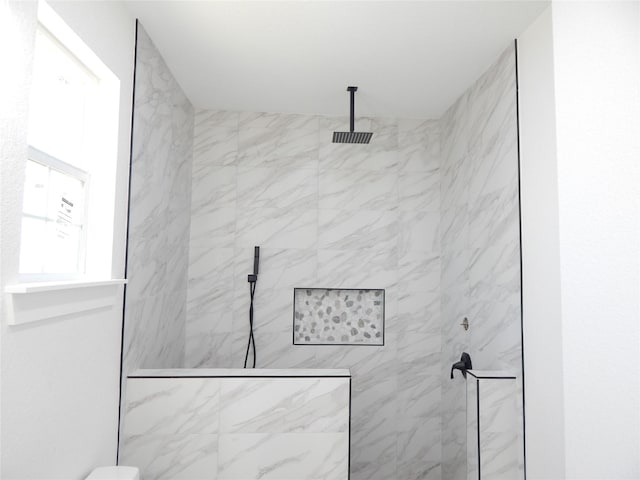 full bathroom with a marble finish shower