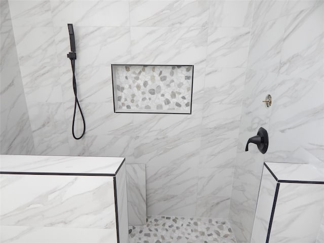 full bathroom featuring a marble finish shower