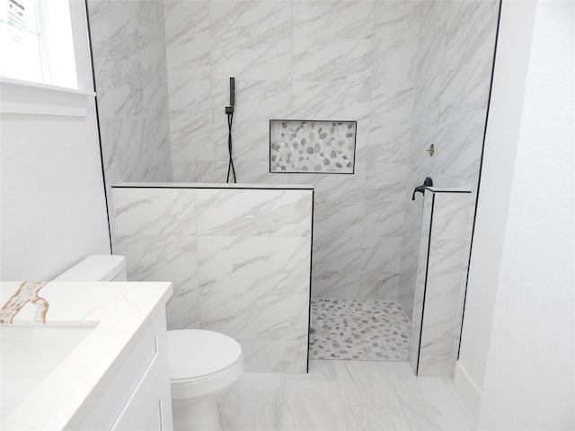 full bathroom with marble finish floor, vanity, a marble finish shower, and toilet