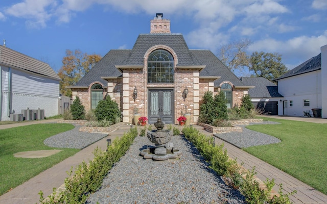 french country style house with a front lawn