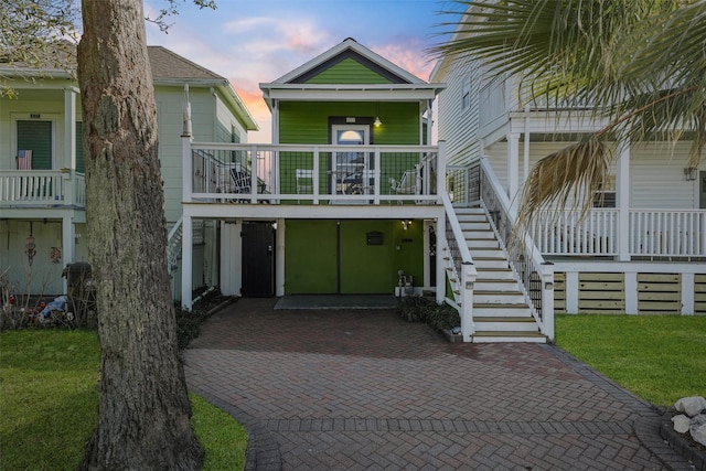 view of front facade with covered porch and a lawn