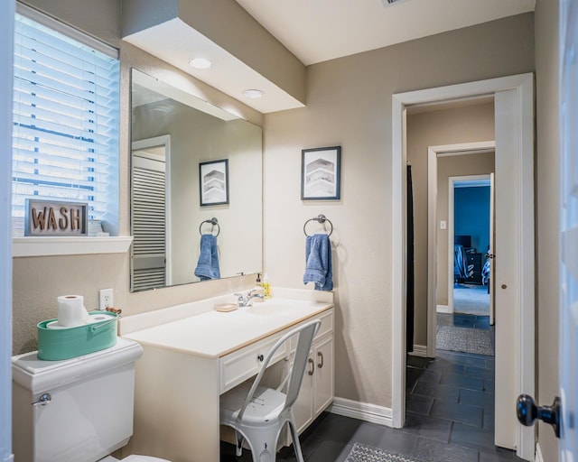 bathroom with toilet and vanity