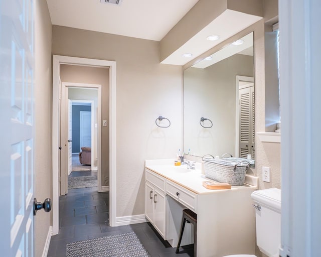 bathroom featuring tile patterned floors, toilet, and vanity