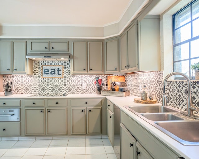 kitchen with sink, cooktop, light tile patterned floors, ventilation hood, and ornamental molding