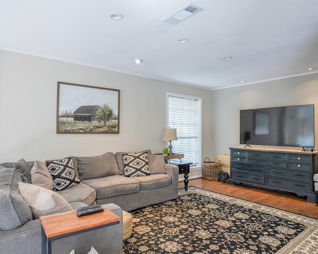 living room featuring ornamental molding and wood-type flooring