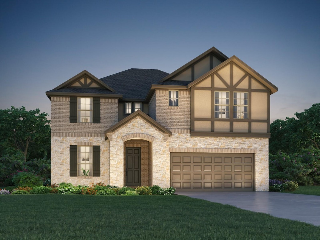 view of front of house featuring a garage and a lawn