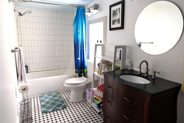 full bathroom with shower / tub combo with curtain, vanity, tile patterned flooring, and toilet