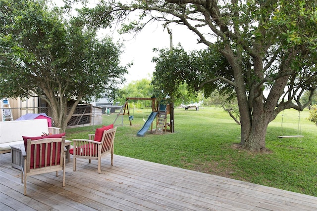 wooden terrace featuring a lawn and a playground