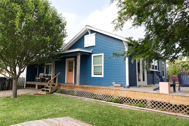 view of front of house featuring a front yard and a deck