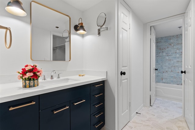 bathroom with tiled shower / bath combo and vanity