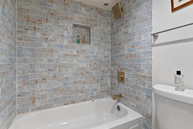 bathroom with shower / bathing tub combination and toilet