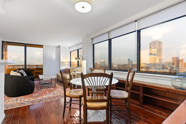 dining room with crown molding and wood-type flooring