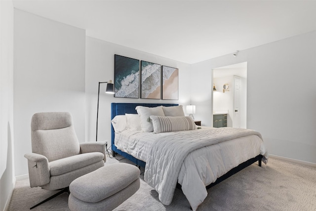 bedroom featuring ensuite bathroom and carpet flooring