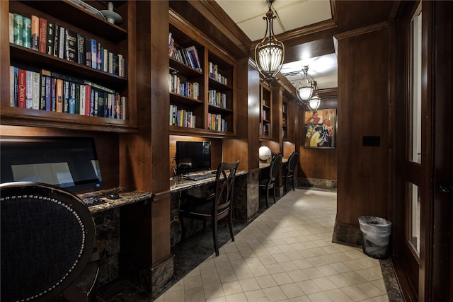 tiled office space with built in features, built in desk, ornamental molding, and wooden walls