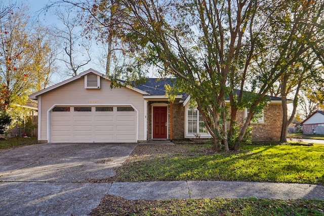 ranch-style home with a garage and a front lawn