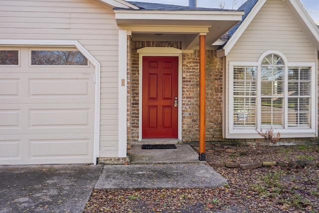 view of exterior entry featuring a garage