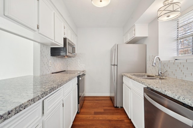 kitchen with sink, white cabinets, dark hardwood / wood-style flooring, and appliances with stainless steel finishes