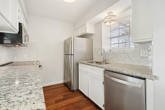 kitchen featuring white cabinets, dark hardwood / wood-style flooring, stainless steel appliances, sink, and light stone counters