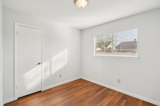 unfurnished room with hardwood / wood-style floors