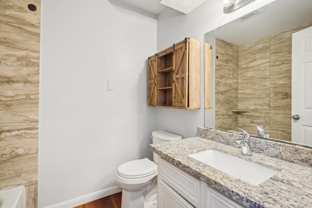 bathroom featuring hardwood / wood-style flooring, toilet, and vanity