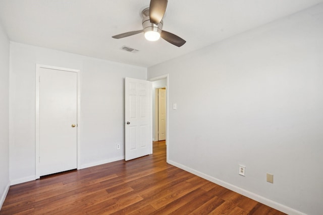 unfurnished bedroom with ceiling fan and dark hardwood / wood-style floors