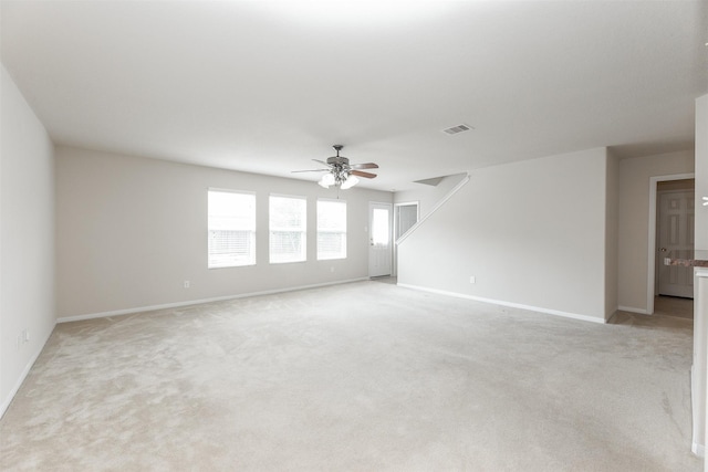 empty room featuring light colored carpet and ceiling fan