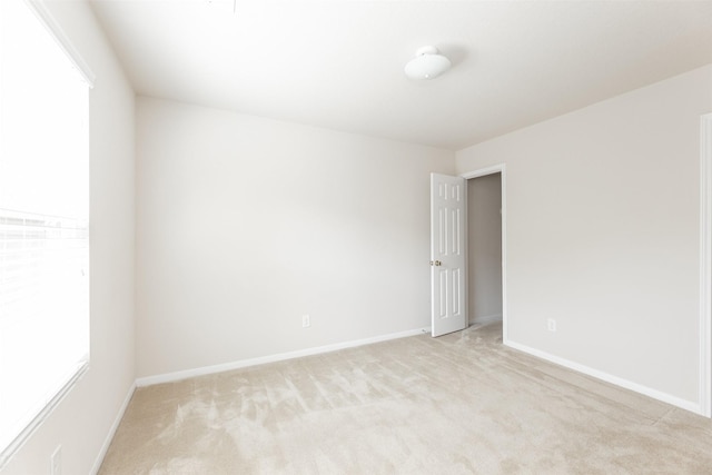 spare room with light colored carpet