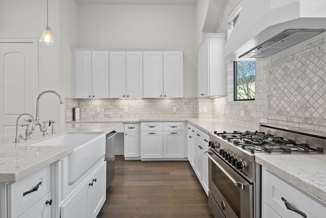 kitchen with white cabinetry, sink, custom range hood, and appliances with stainless steel finishes